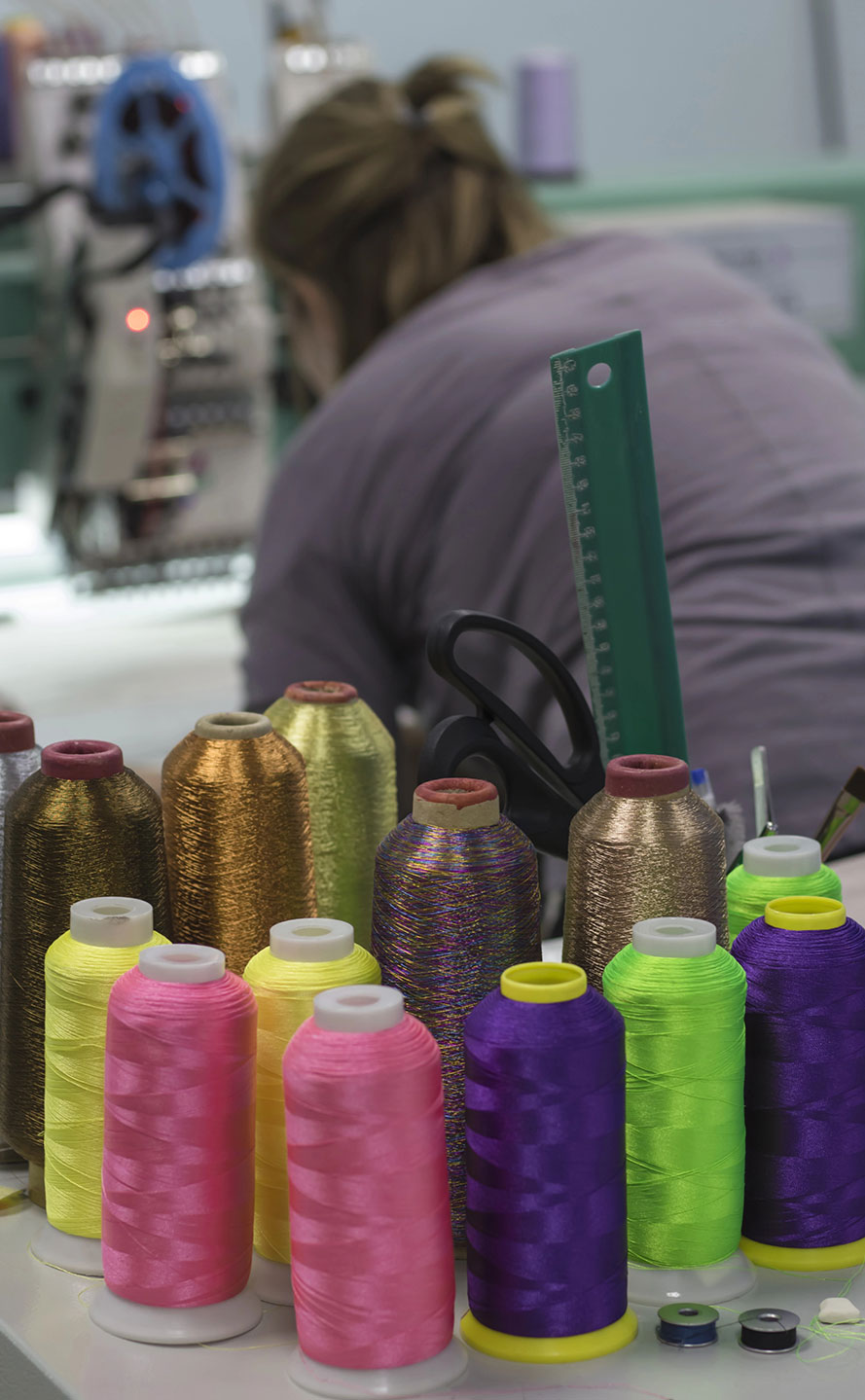 Colored threads are on the table for embroidery on a modern embroidery machine